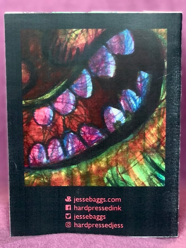 Back cover to Jesse Baggs's "Piercing the Veil" mini-art book, depicting a grinning, leering mouth full of broken, purple teeth surrounded by colorful fur.