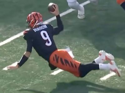Screenshot from YouTube video “Joe Burrow WITH AN INSANE FALLING DOWN TOUCHDOWN PASS Bengals vs Browns,” posted by @lisabtheplug5630 on Dec. 12, 2024, https://www.youtube.com/shorts/S_-kGgVuTmc. The image captures Detroit Bengals quarterback Joe Burrow falling forward almost face first but still managing to pull back his right arm to make a pass. Accessed on 11/18/25.